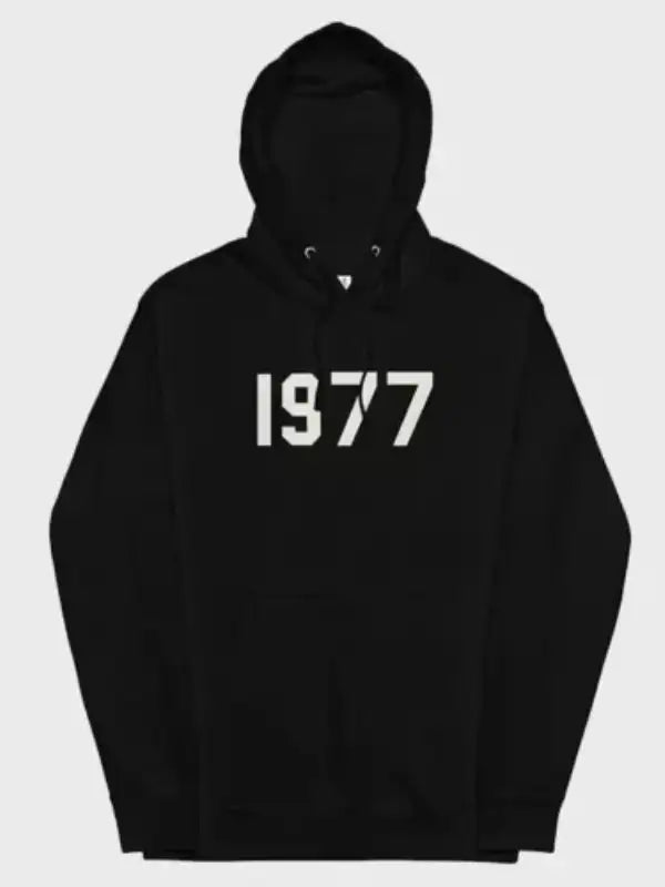 Front view of the 1977 essentials hoodie black pullover with the white'1977' logo across the chest.