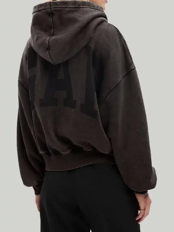 Back view of a woman wearing a dark brown hoodie featuring 'GAP' logo across the back.
