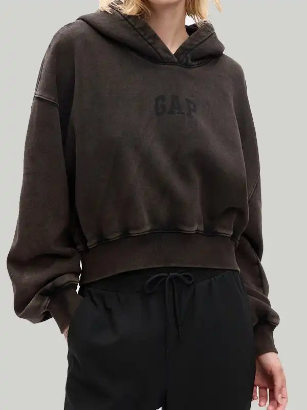 Front view of a woman wearing a brown hoodie 'GAP' logo